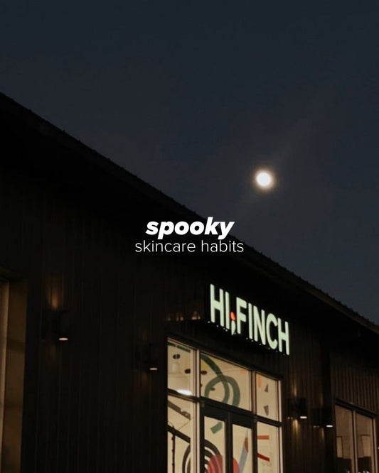 Exterior of Hi, Finch skincare clinic at night with illuminated signage, under a full moon; text overlay reads “spooky skincare habits.”