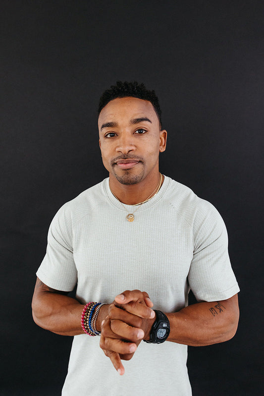 Man looking into the camera with hands clasped