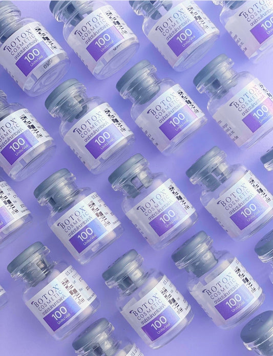 Multiple vials of Botox Cosmetic 100 units arranged in a diagonal pattern on a lavender background